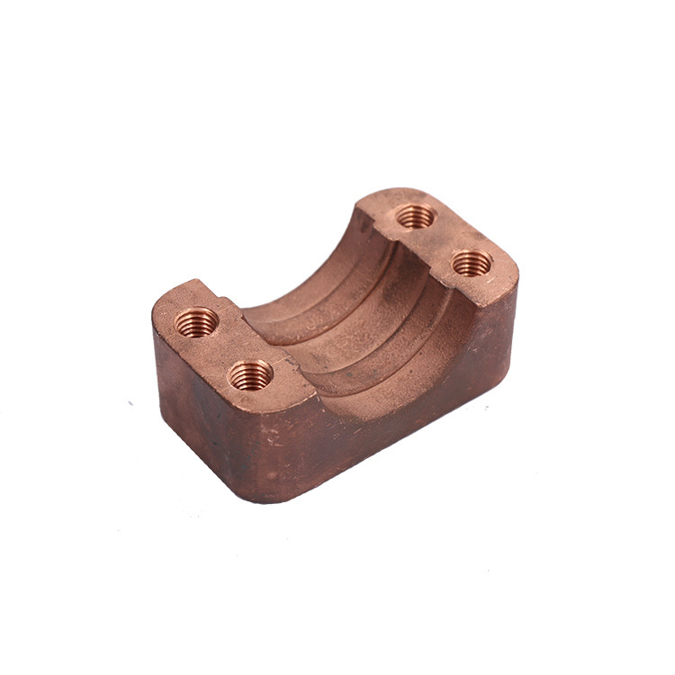 CNC machined bronze clamp block with twin radiused seats and tapped holes, machined by GY Machining