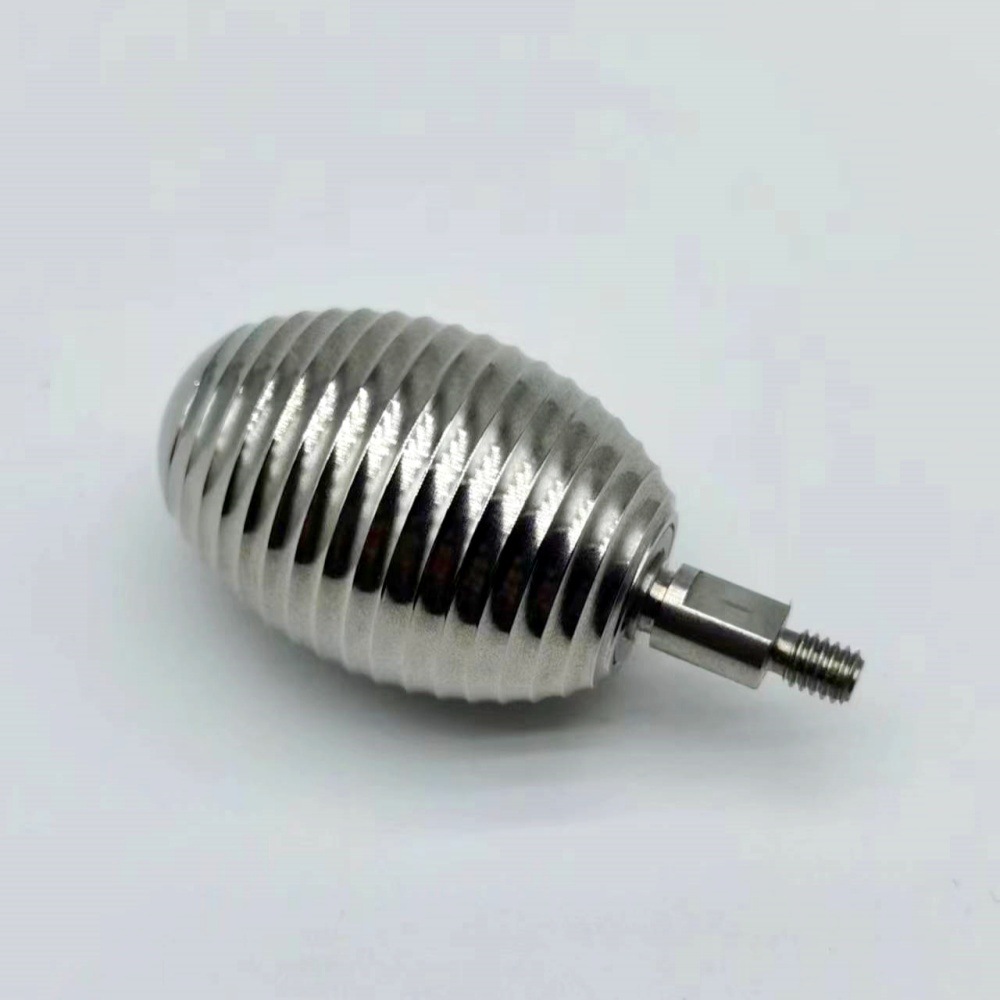 CNC turned stainless steel ribbed spiral body with a threaded stud, machined by GY Machining