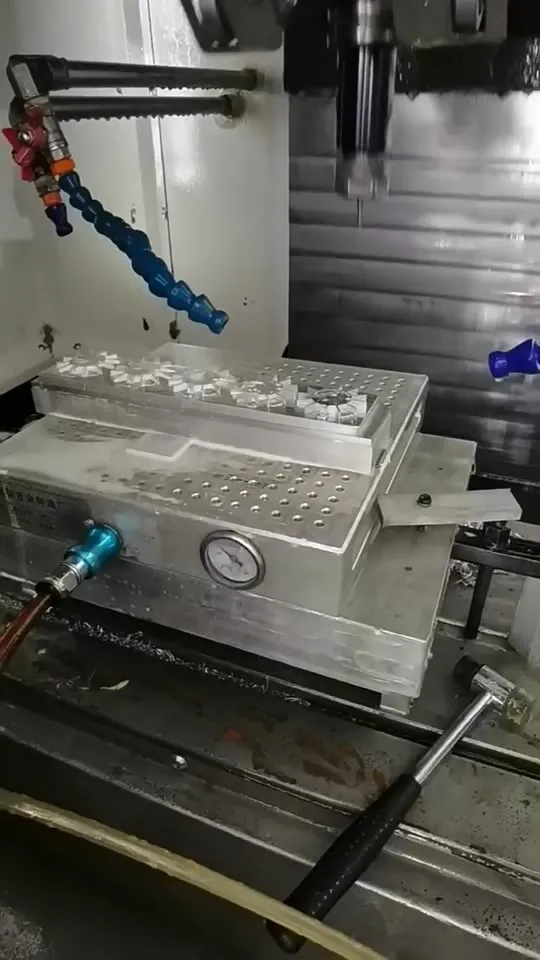 Thin aluminium heatsink held on a vacuum fixture inside a CNC machining centre