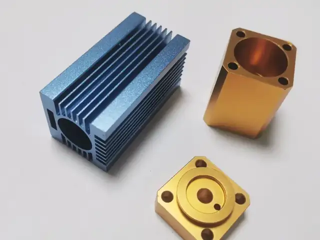 Anodised aluminium blue heat sink and gold anodised blocks machined at GY Machining