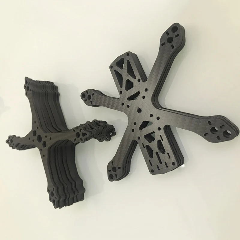 CNC cut carbon fibre drone frame plates, stacked in batches