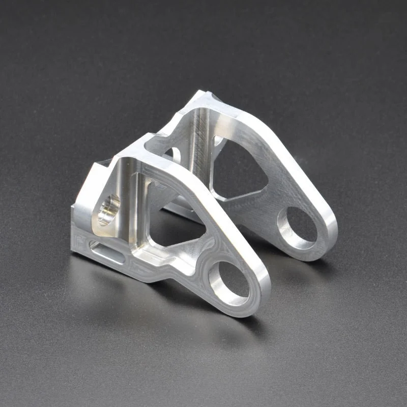Matched pair of CNC machined aluminium bracket arms with pocketed webs and reamed pivot bores – GY Machining