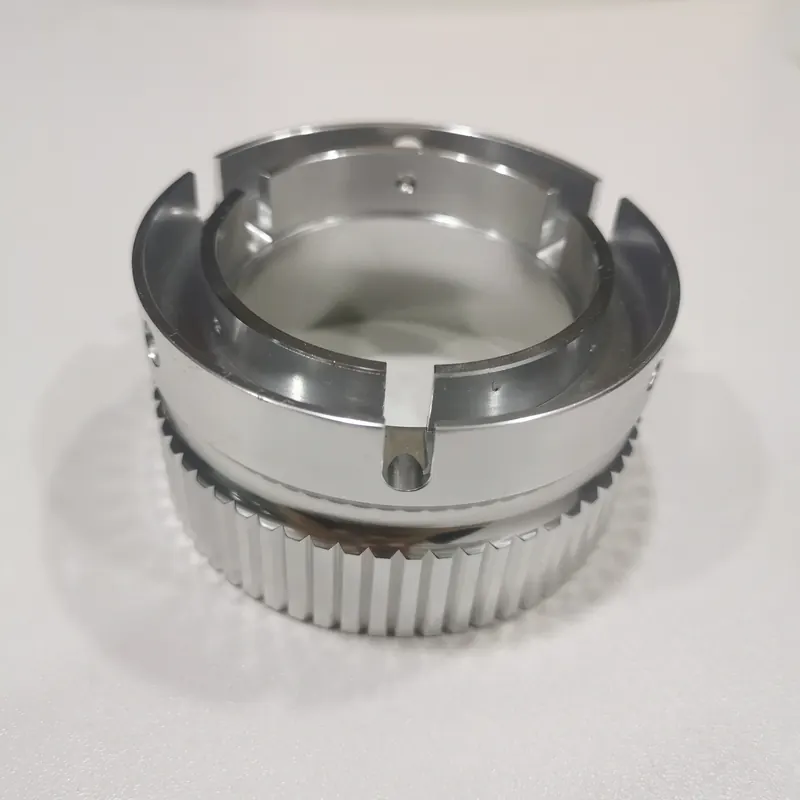 CNC machined aluminium ring with milled serrations, bayonet slots and cross-drilled holes, machined by GY Machining