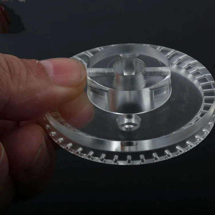 CNC machined clear acrylic disc with a slotted rim, raised hub and cross-drilled bore