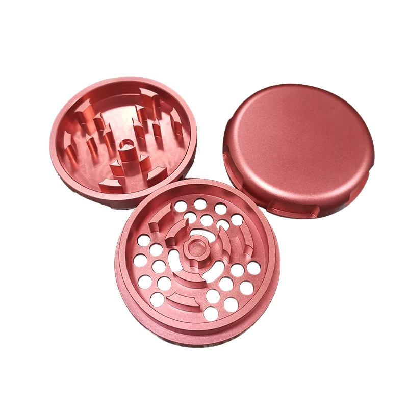 Three-piece CNC machined grinder: lid, toothed grinding chamber and perforated screen, machined by GY Machining