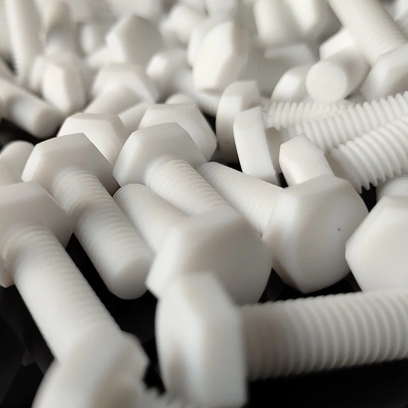Close-up of CNC turned PTFE hex bolts showing the machined threads