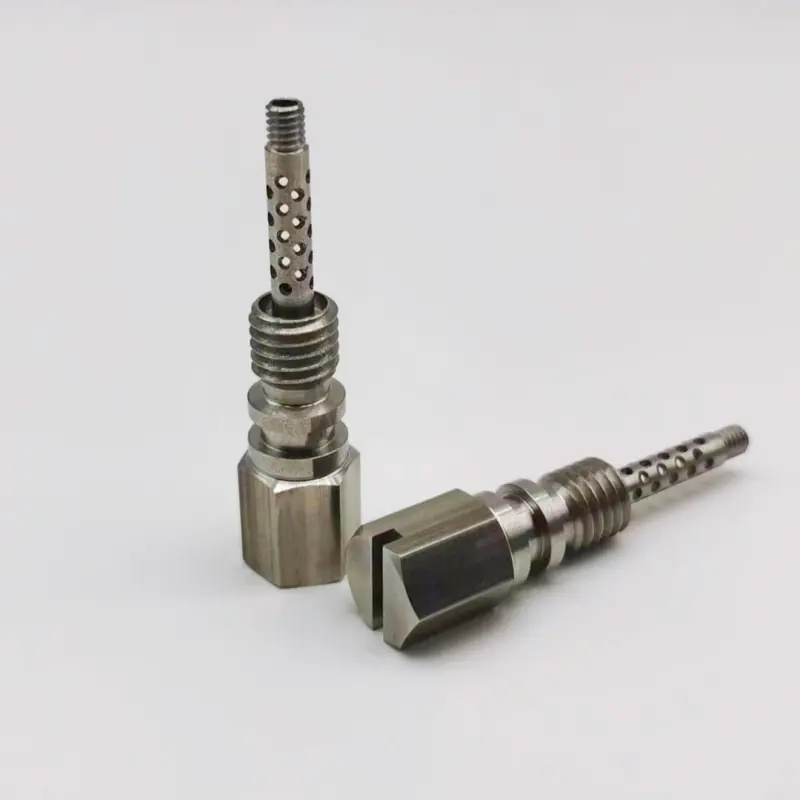 CNC machined stainless steel adapter fittings with a perforated screen section, hex body and threaded neck, machined by GY Machining
