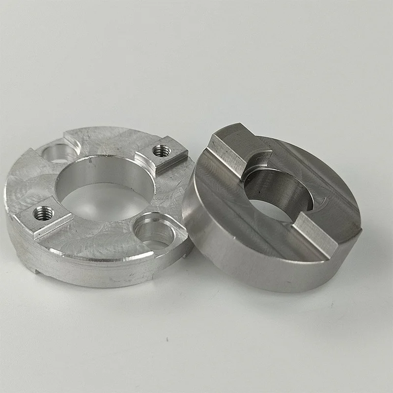 CNC milled aluminium flange and turned stainless steel slotted collar, machined by GY Machining