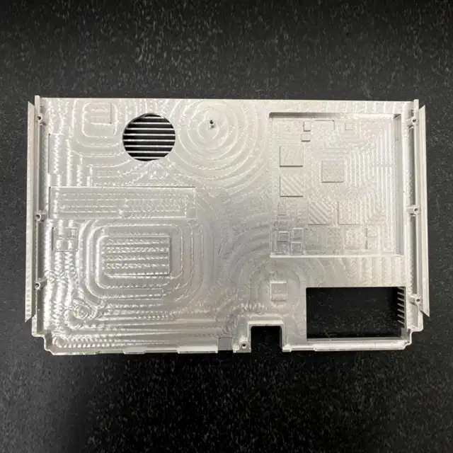 CNC milled aluminium cover plate with vent slots, pockets and mounting