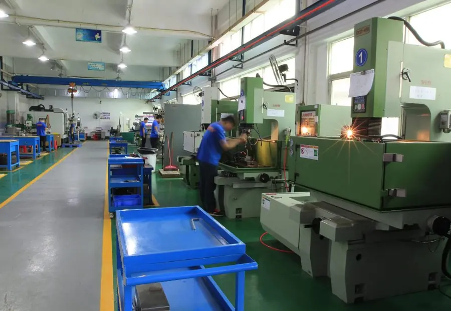 Row of wire and sinker EDM machines on the GY Machining shop floor in Dongguan