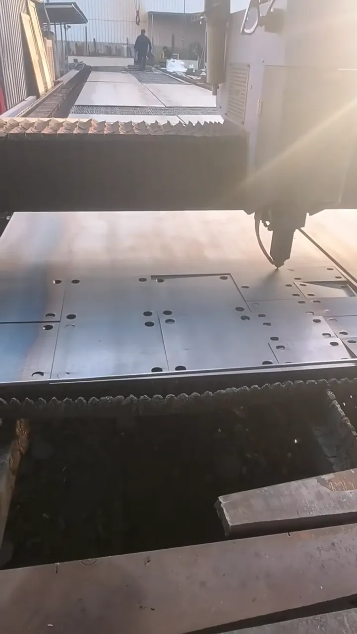 Fibre laser cutting head cutting nested parts from steel plate at the partner plant GY Machining uses