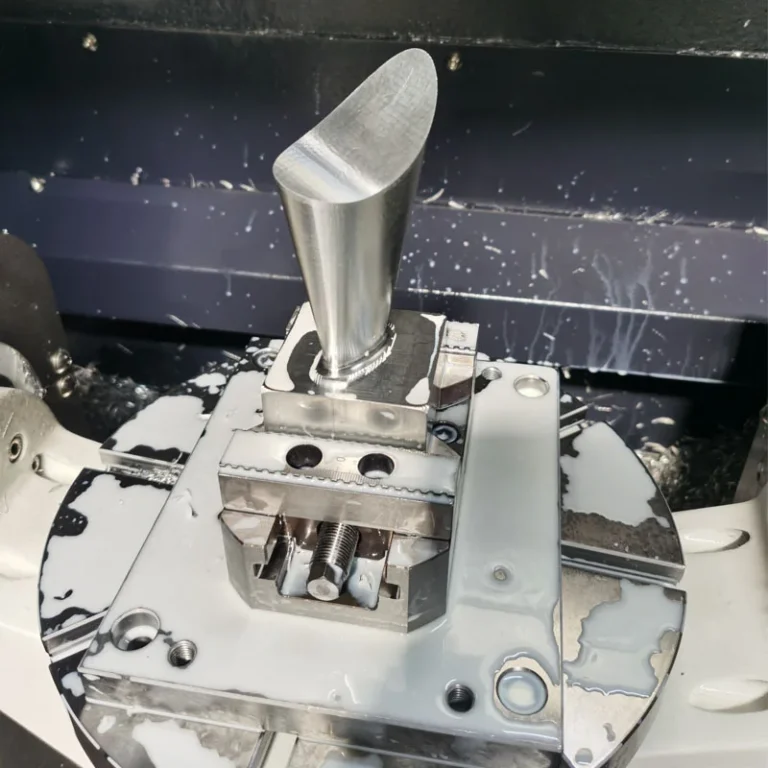 Four-axis CNC milling of a stainless steel blade held in a vise, in the machine at GY Machining