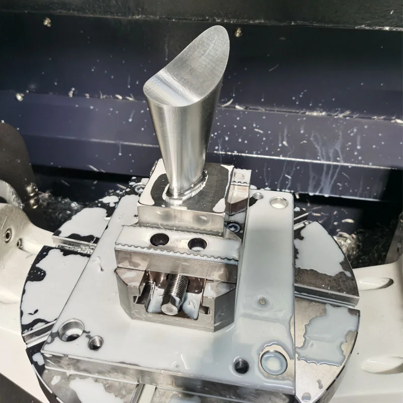 Four-axis CNC milling of a stainless steel blade held in a vise, in the machine at GY Machining
