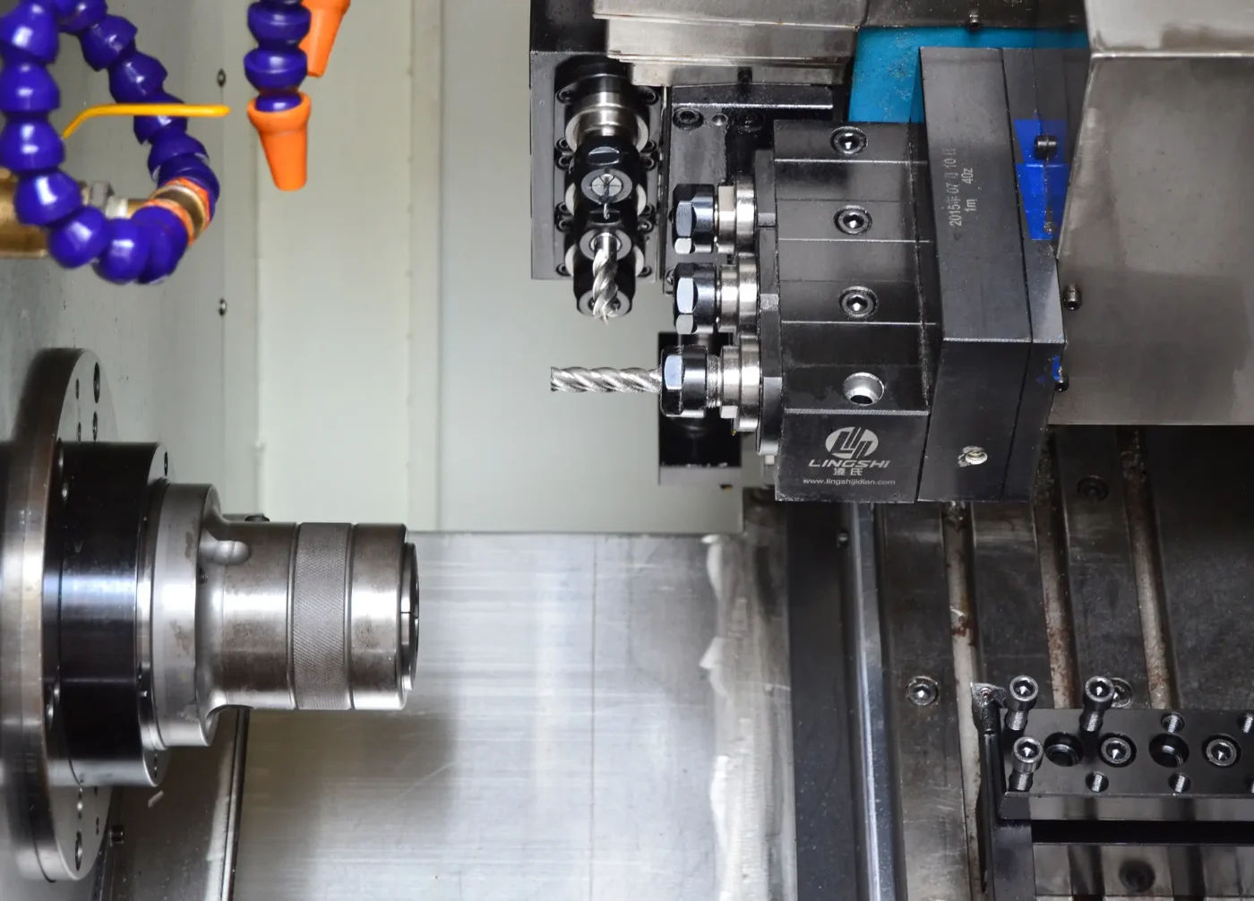 Gang-tool CNC lathe with live tooling – driven end mills on the tool block and a knurled part in the collet chuck – GY Machining, Dongguan
