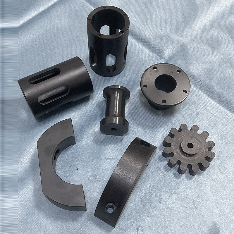 Machined black nylon bushings, sleeves and a gear