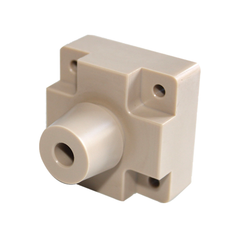 Machined PEEK housing block with turned boss and tapped holes — PEEK, CNC machined at GY Machining