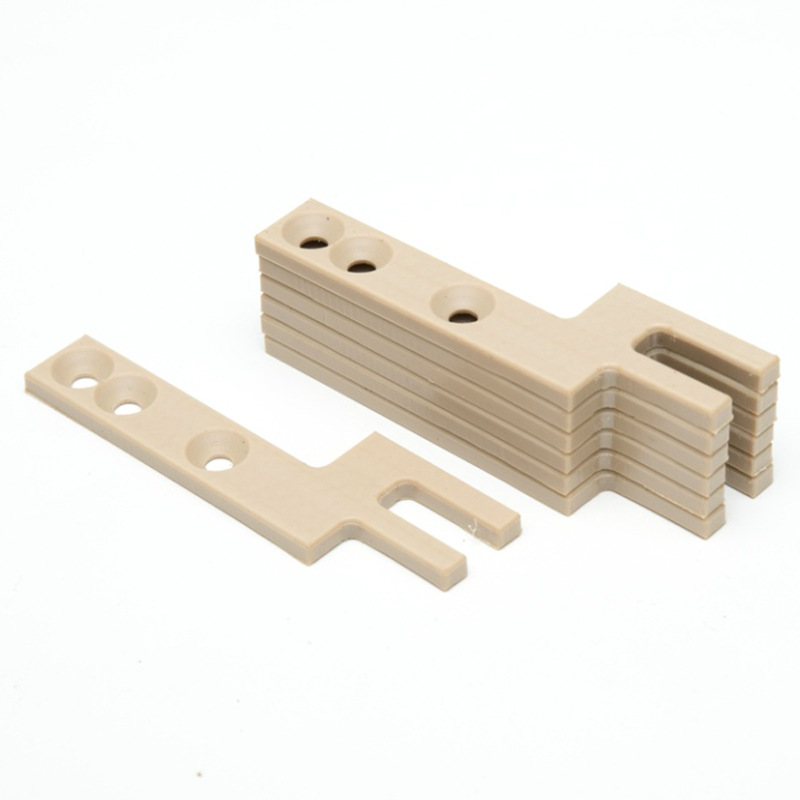 Machined PEEK slotted bars, stacked batch — PEEK, CNC machined at GY Machining