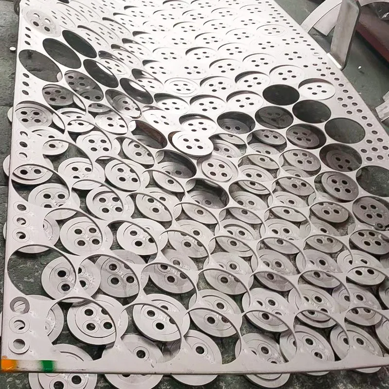 Laser-cut stainless steel discs still nested in the sheet skeleton at the partner plant