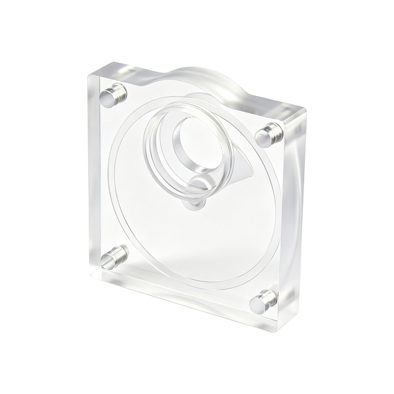 CNC machined clear acrylic plate with a bored pocket and pressed pins