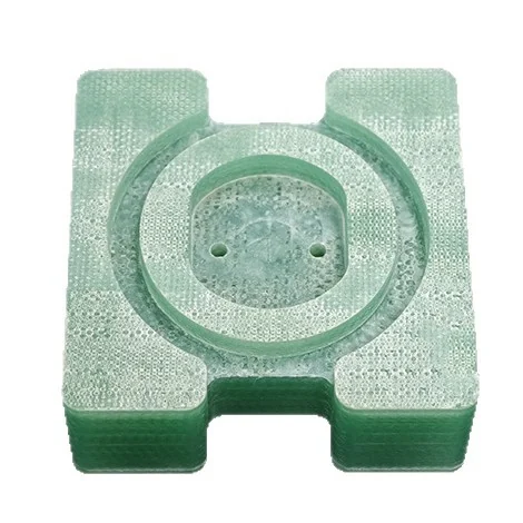 Thick G10 block with a circular pocket, the glass weave visible in the cut face &ndash; GY Machining