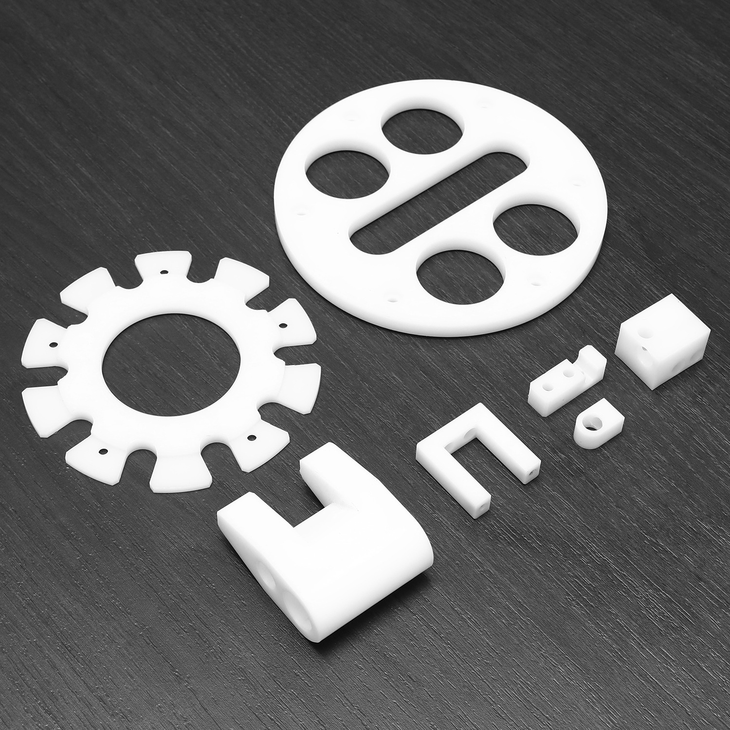 CNC machined natural Delrin discs, blocks and brackets