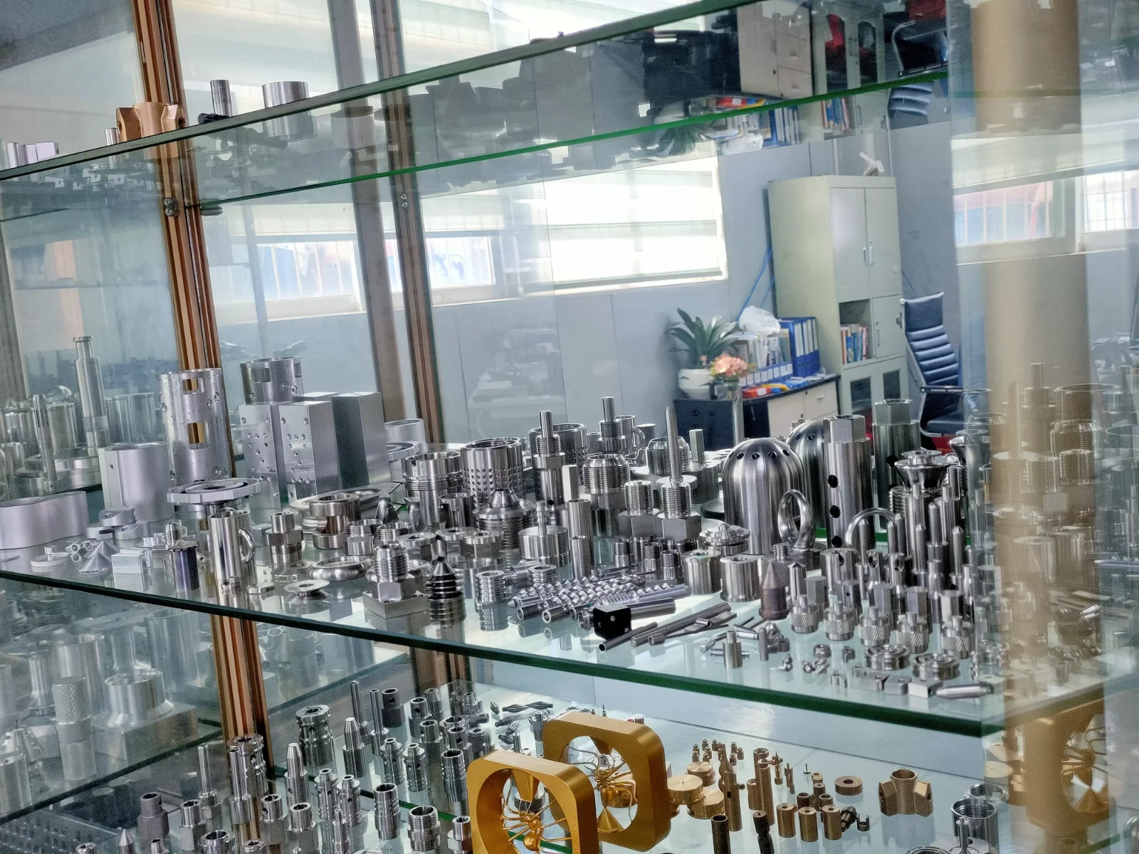 Sample cabinet shelf at GY Machining: CNC turned and milled stainless steel, brass and gold anodised aluminium parts