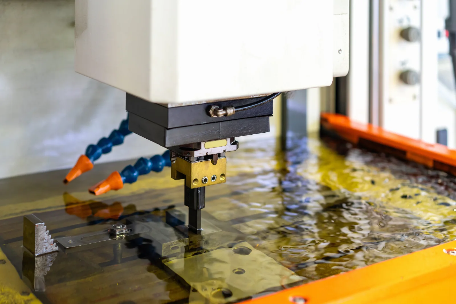 Sinker EDM electrode cutting a steel part – GY Machining
