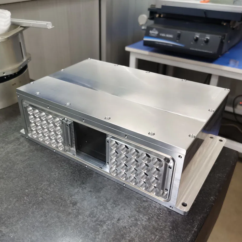Milled aluminium telecom equipment enclosure with dimpled vent panels, machined at GY Machining
