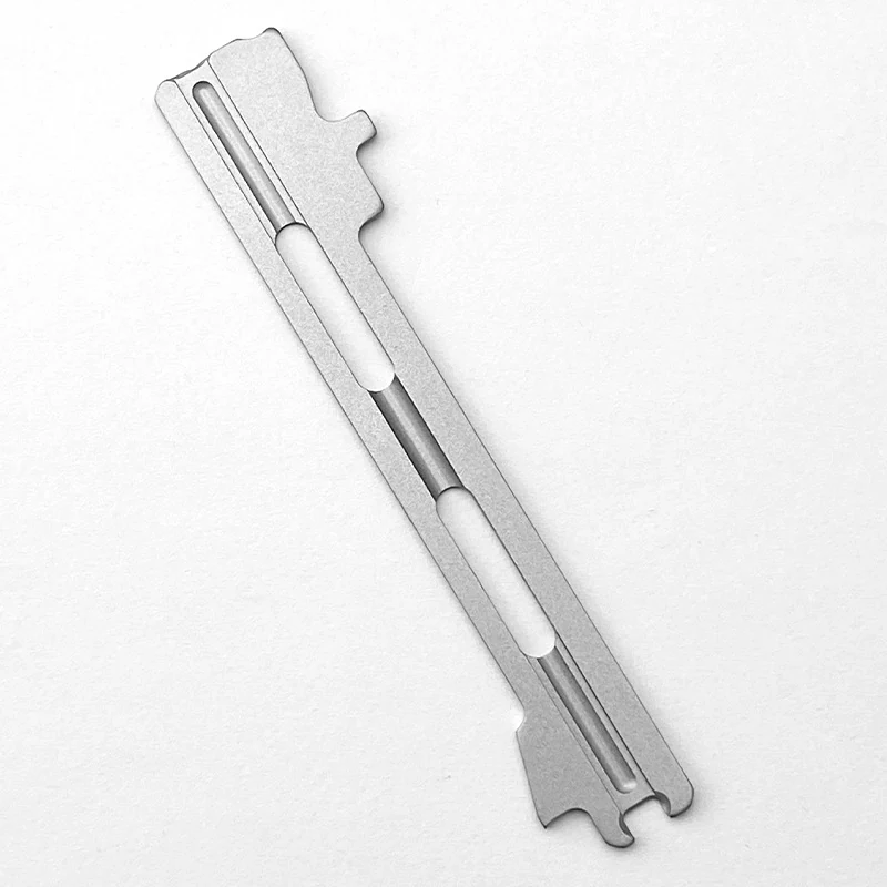 Machined titanium knife liner with milled relief slots and a stonewashed finish