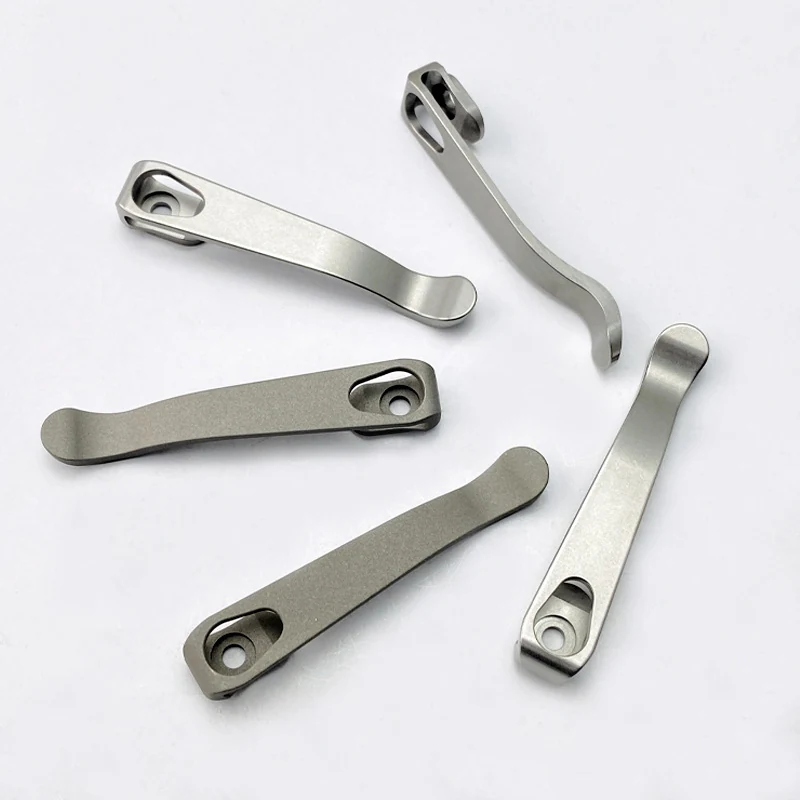 Five machined and formed titanium pocket clips for folding knives, stonewashed
