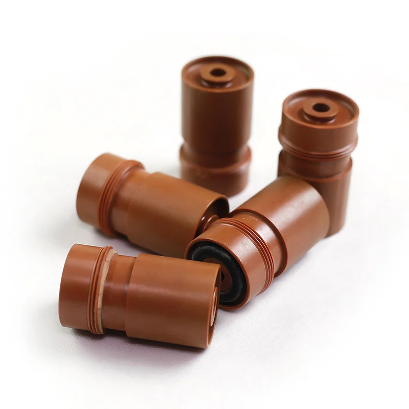 Turned brown PAI bushings with grooves and fitted O-rings &ndash; GY Machining