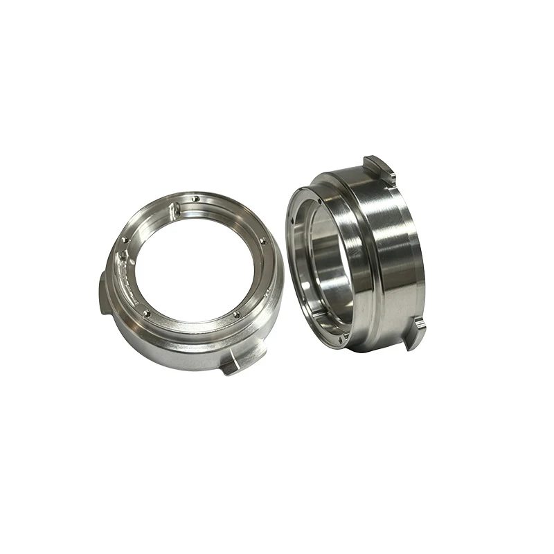 Pair of turned and milled stainless steel bayonet mount rings with tabs, threaded holes and a stepped bore