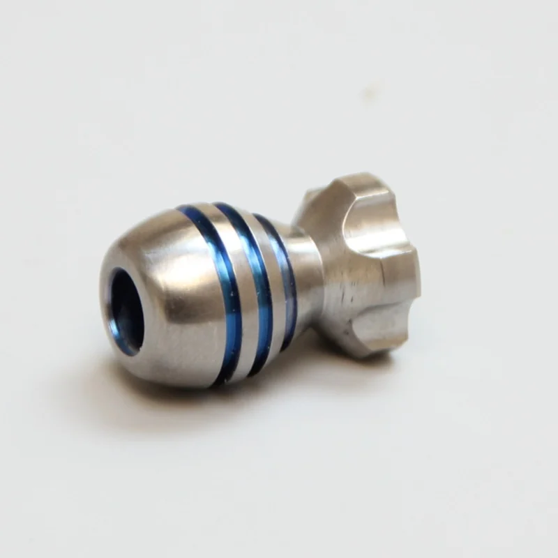 Turned titanium bead with two blue anodised grooves and a fluted head