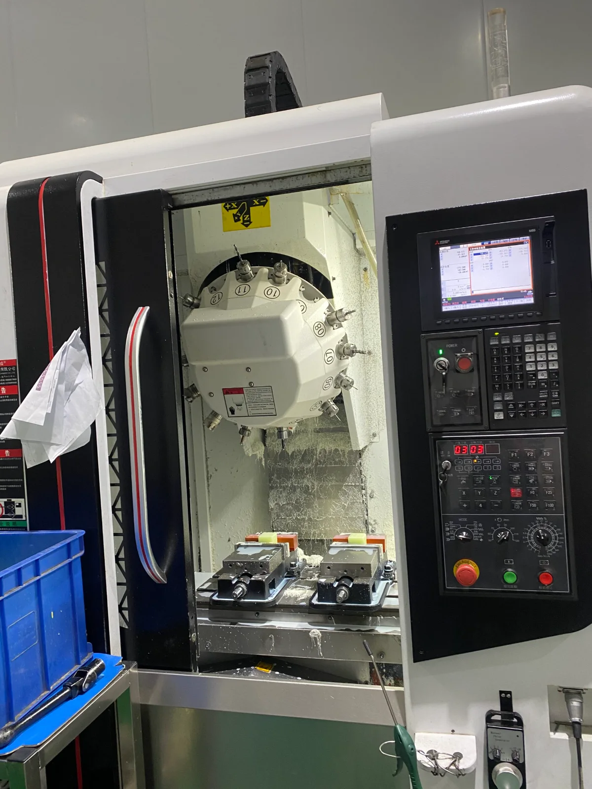 Tool changer and vices inside a vertical machining centre at GY Machining