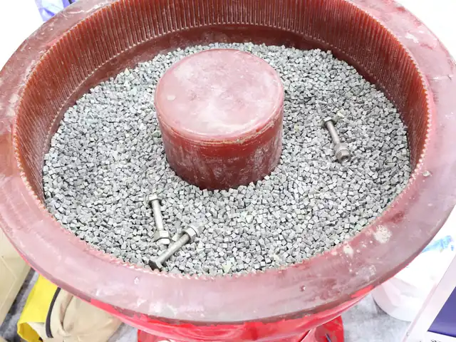 Vibratory tumbler with ceramic media deburring machined bolts and small steel parts